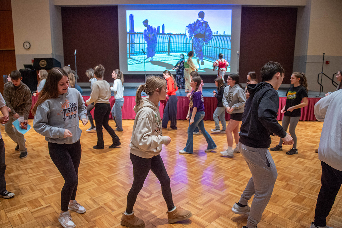 Students dance in a circle during World Languages and Cultures Day at SIU
